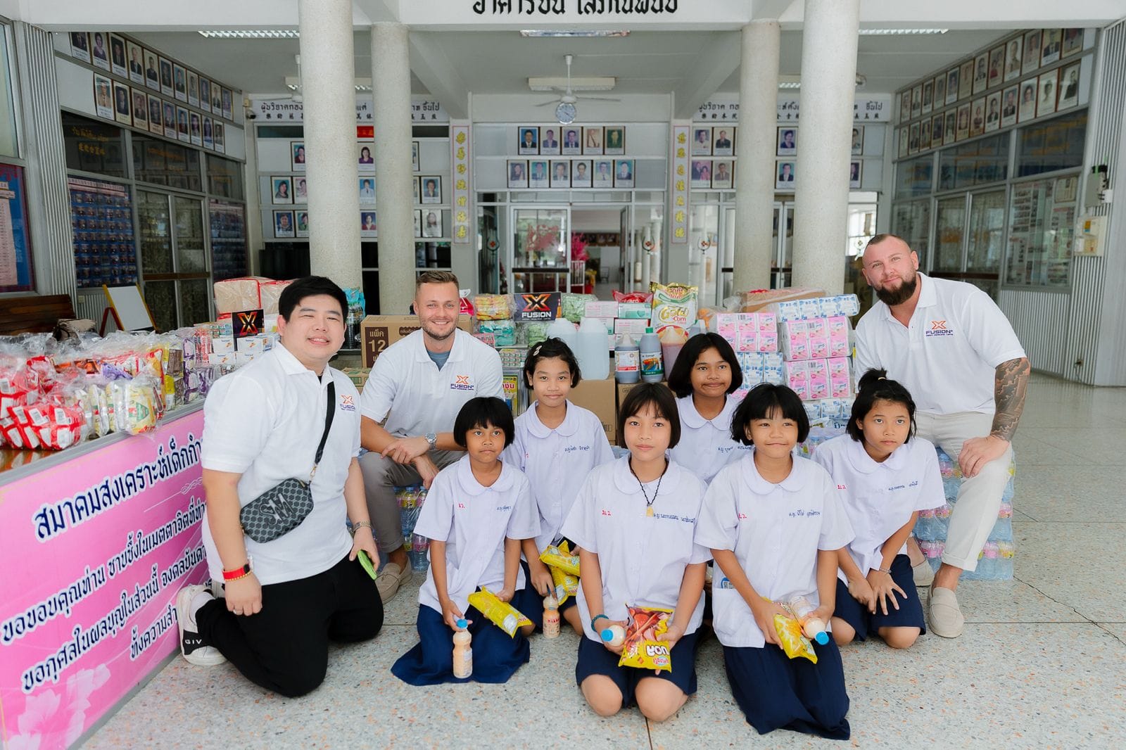 Zeljko Cikojevic and partners with school children during a charity donation event