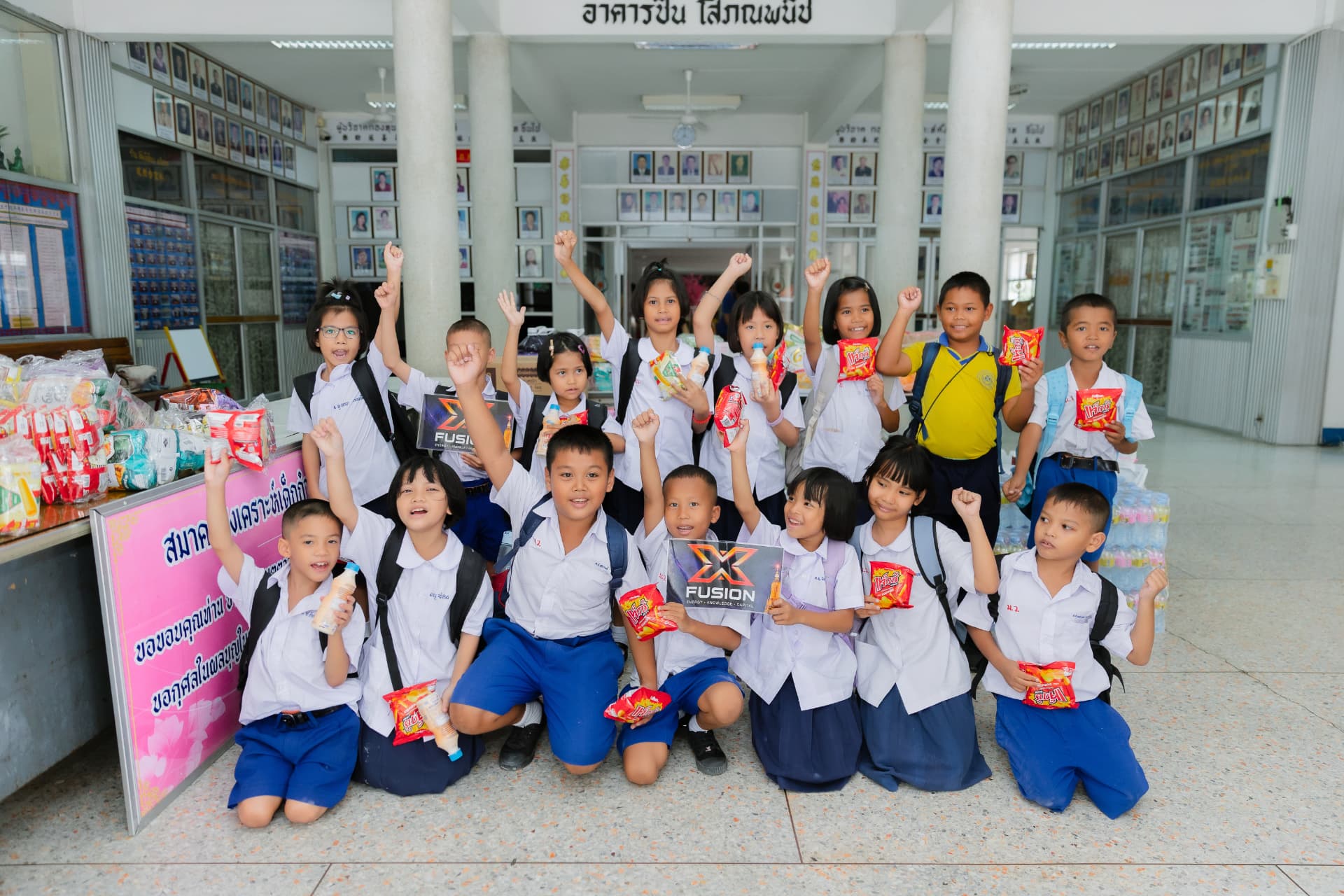 School children celebrating with XFusion donations at a school in Thailand